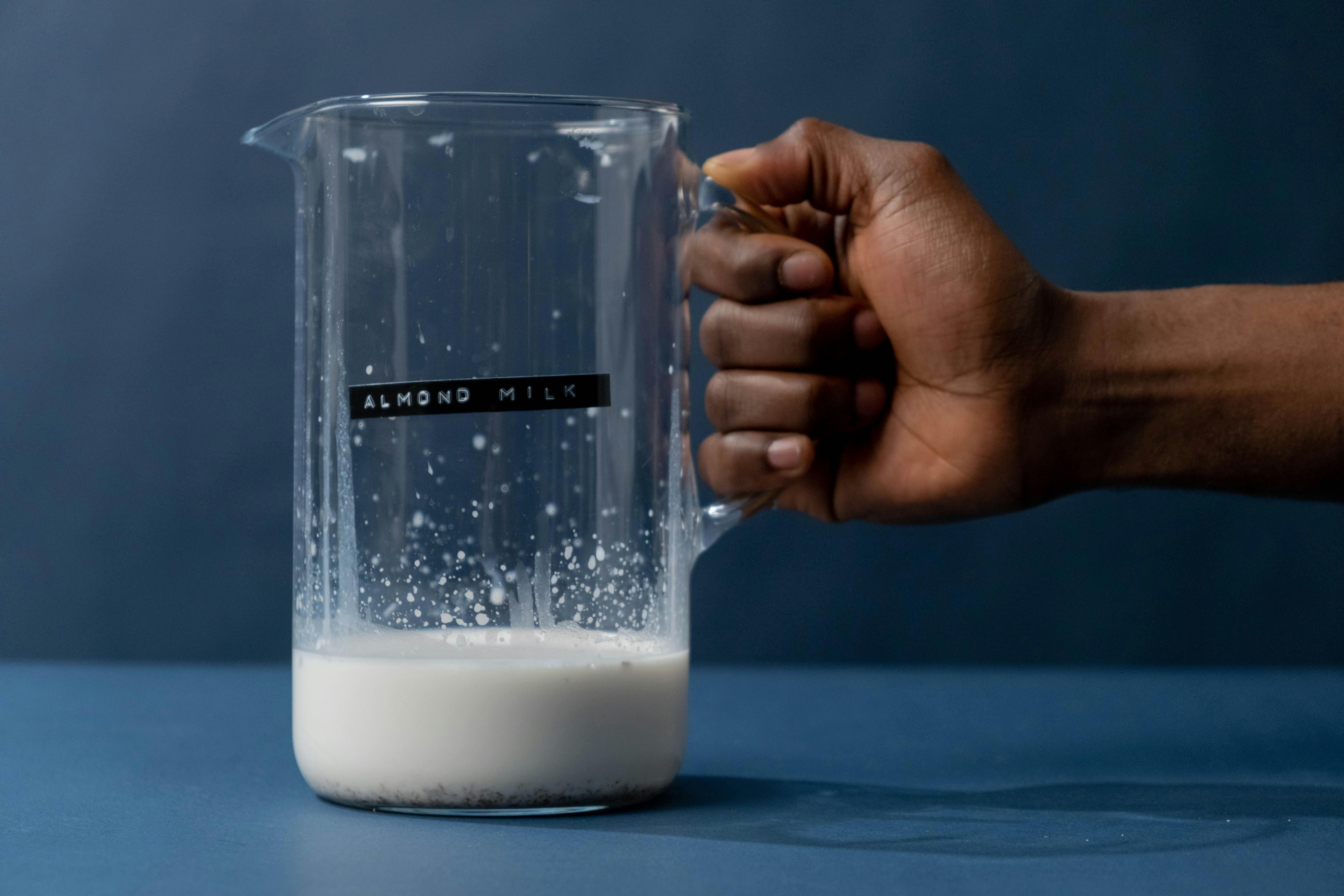 Glass of almond milk on a table, suitable for intermittent fasting