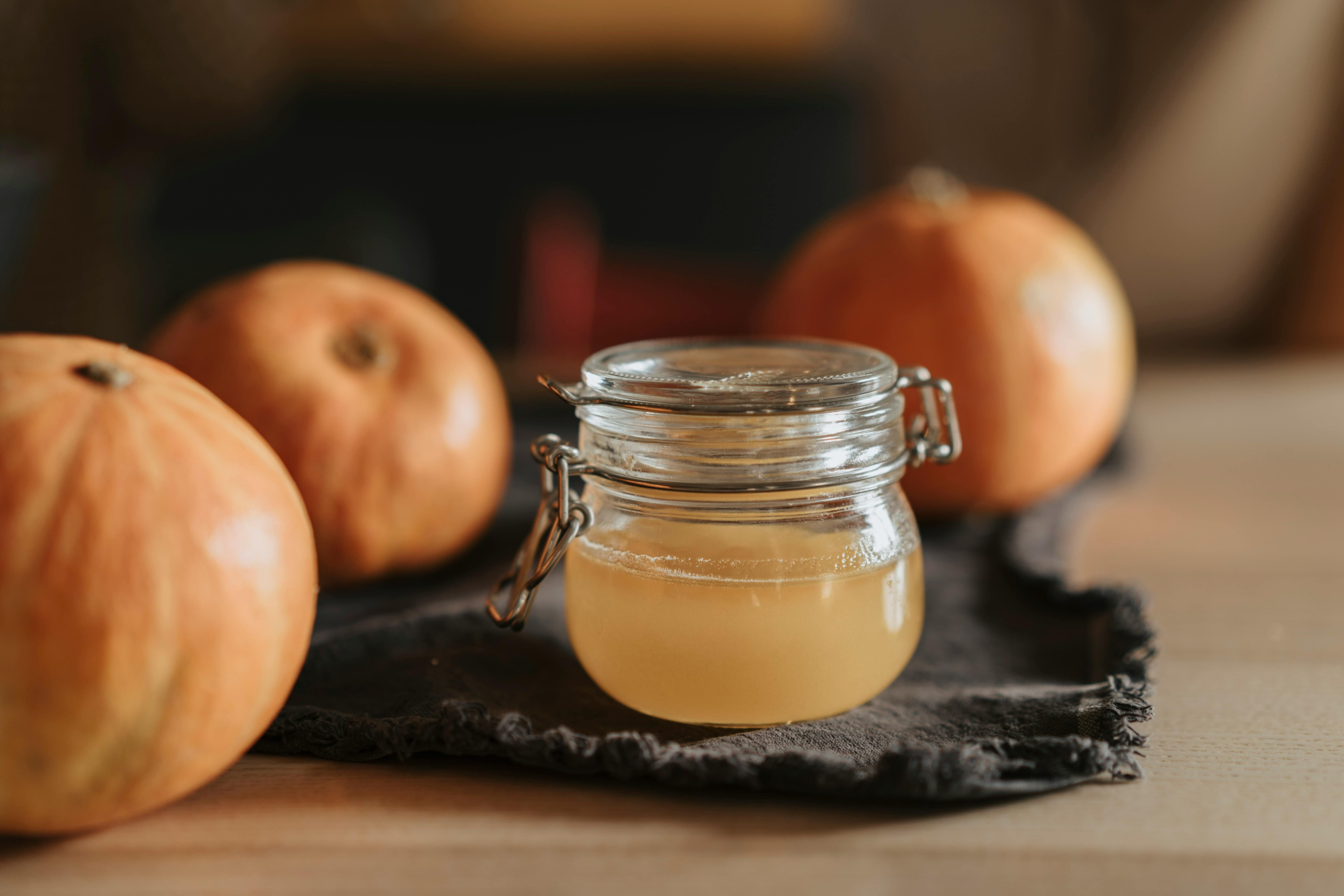 A jar of apple cider vinegar, known for its gut health benefits and aiding digestion with prebiotics and acetic acid.