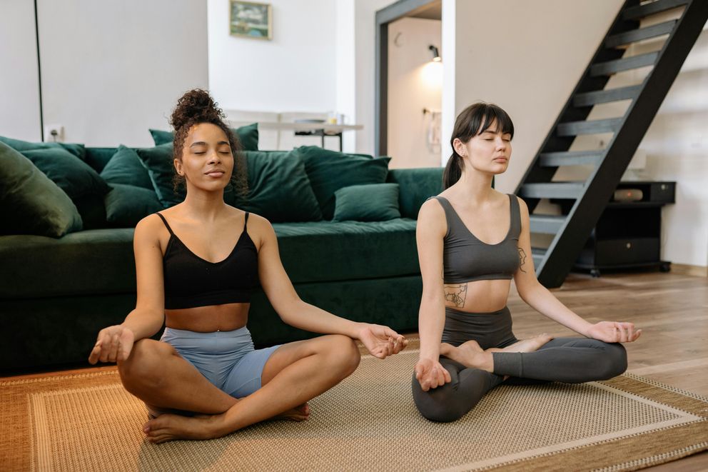 A woman practicing breathwork for weight loss, using techniques like diaphragmatic breathing and box breathing to support stress reduction and fat burning.