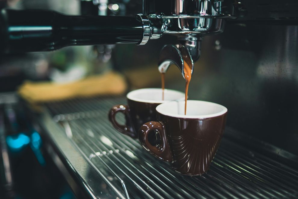 A woman enjoying a cup of coffee while staying hydrated with water, balancing caffeine intake for overall well-being.