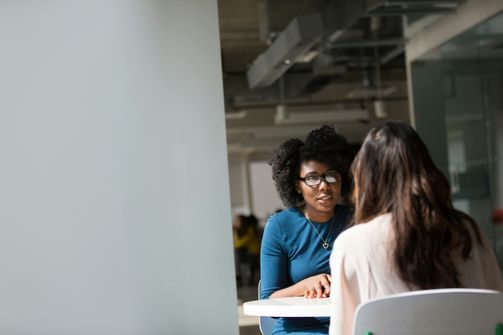 A woman engaging in therapy with a gender lens, learning to challenge societal pressures affecting her mental health.