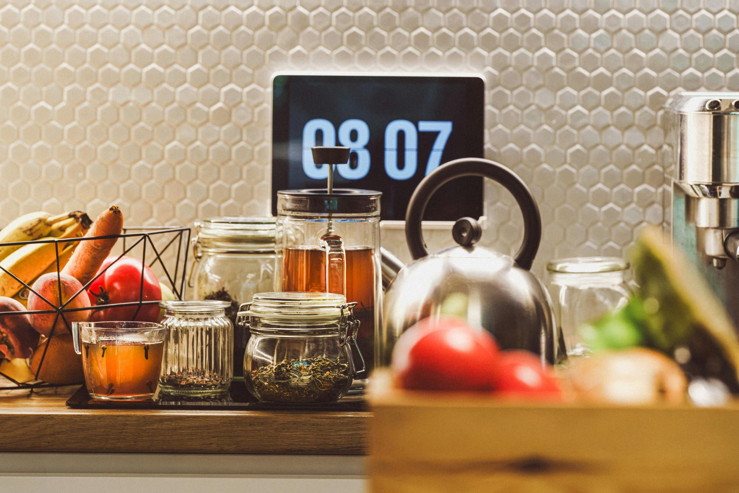 A clock surrounded by healthy foods, representing circadian fasting and timed eating for optimal health.