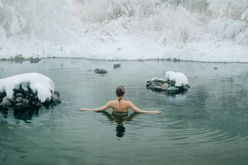 A woman practicing cold exposure for weight loss, using techniques like cold showers, ice baths, and cryotherapy.