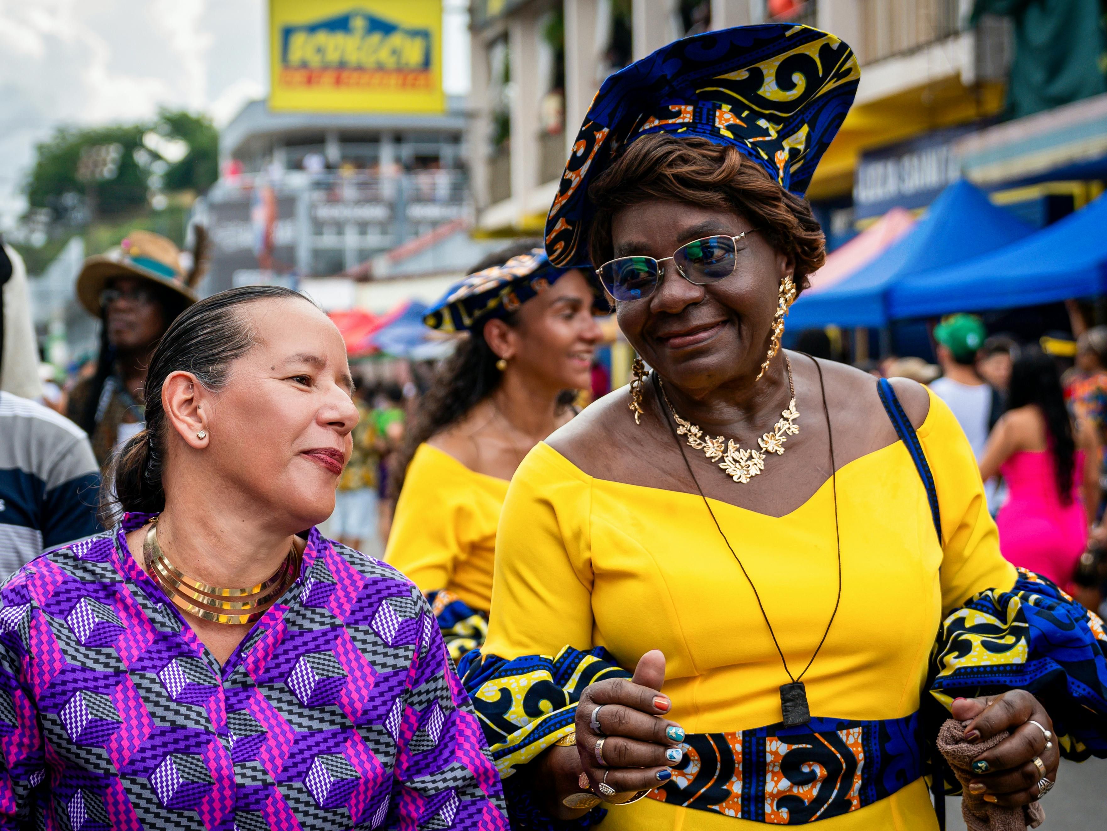 Costa Rican women celebrating at a local festival, embracing community and cultural traditions that contribute to longevity in Nicoya, a Blue Zone region.