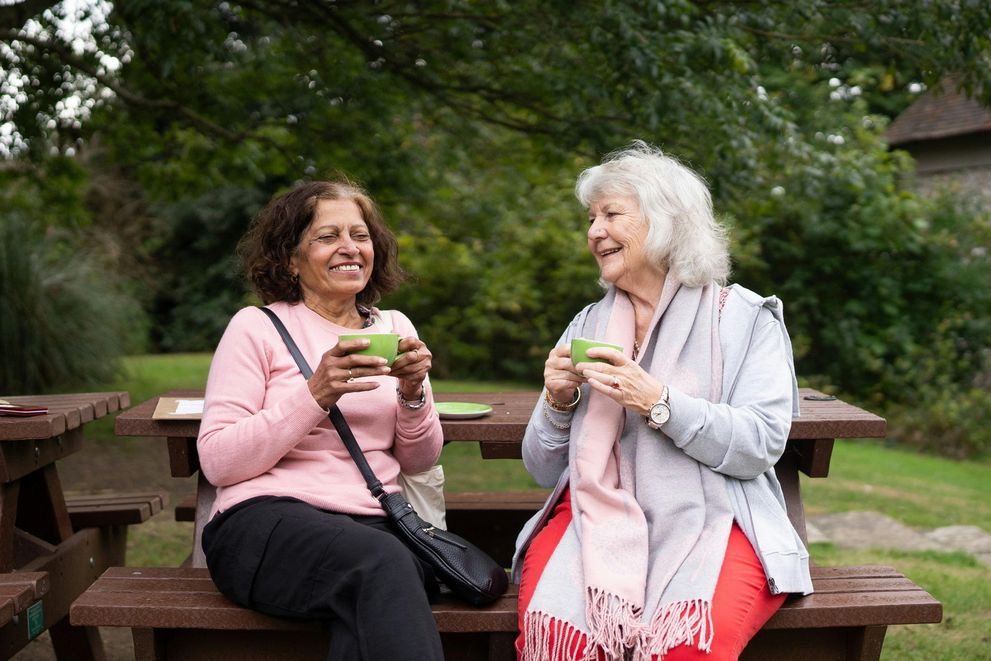 A woman enjoying a cup of herbal tea for hormonal balance and stress relief, enhancing her overall wellness.