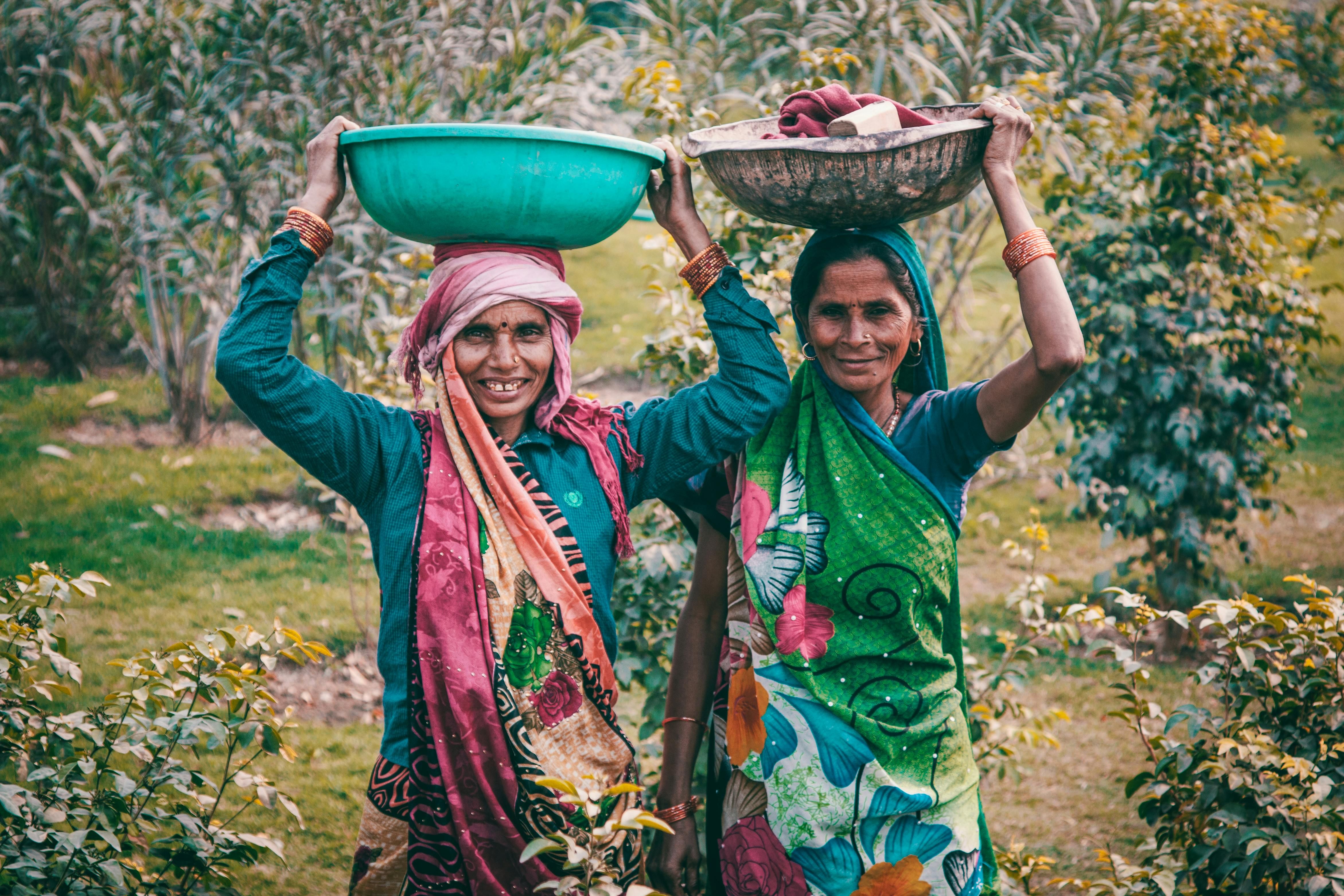 Two Indian women performing outdoor chores, reflecting traditional lifestyle while exploring different cultural approaches to the carnivore diet.