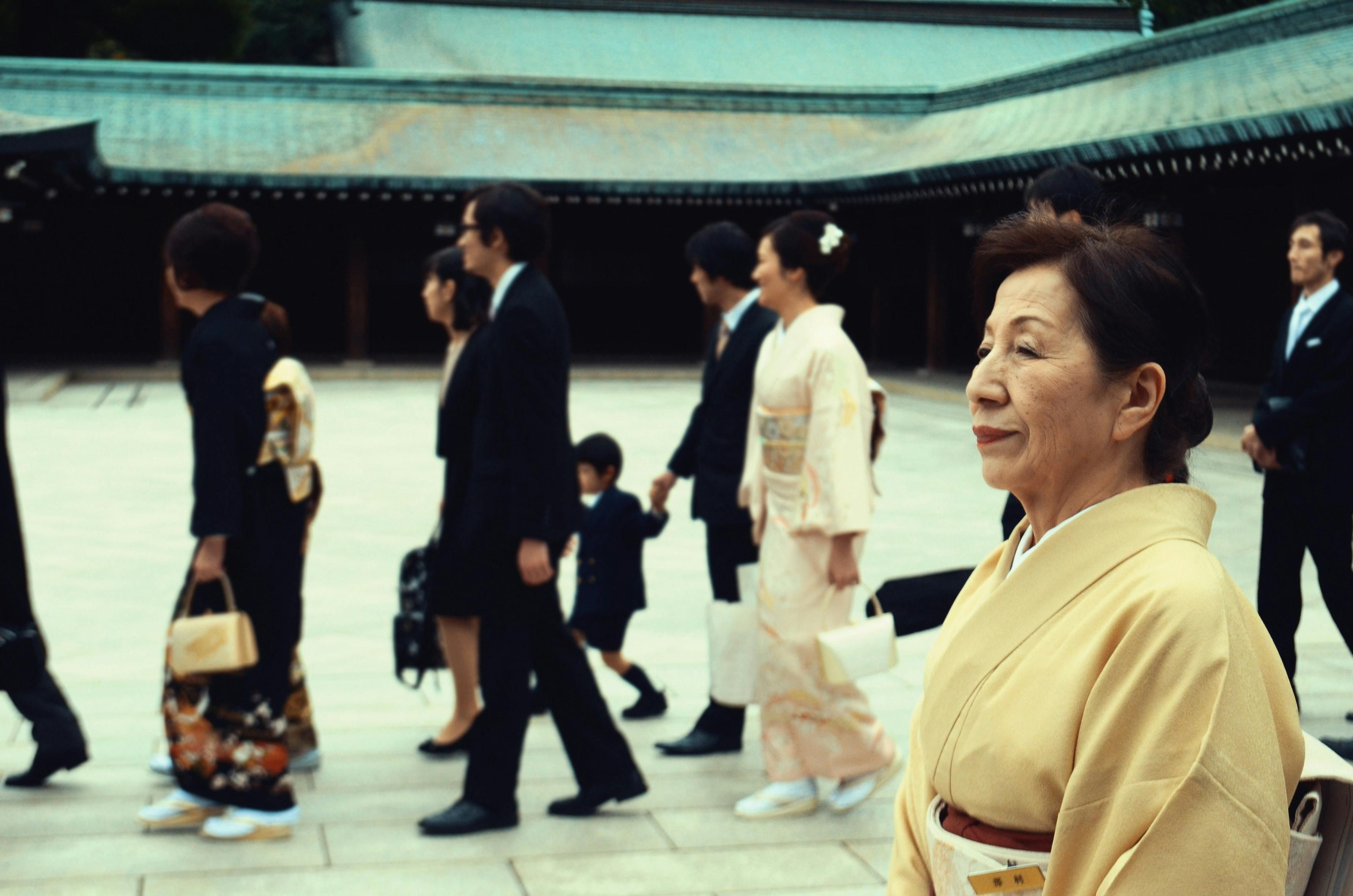 An older Japanese woman smiling, representing the longevity and healthy lifestyle practices of women from Okinawa, Japan, a Blue Zone region.