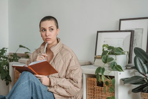 A woman practicing visual journaling to unlock emotional clarity and enhance mental health.