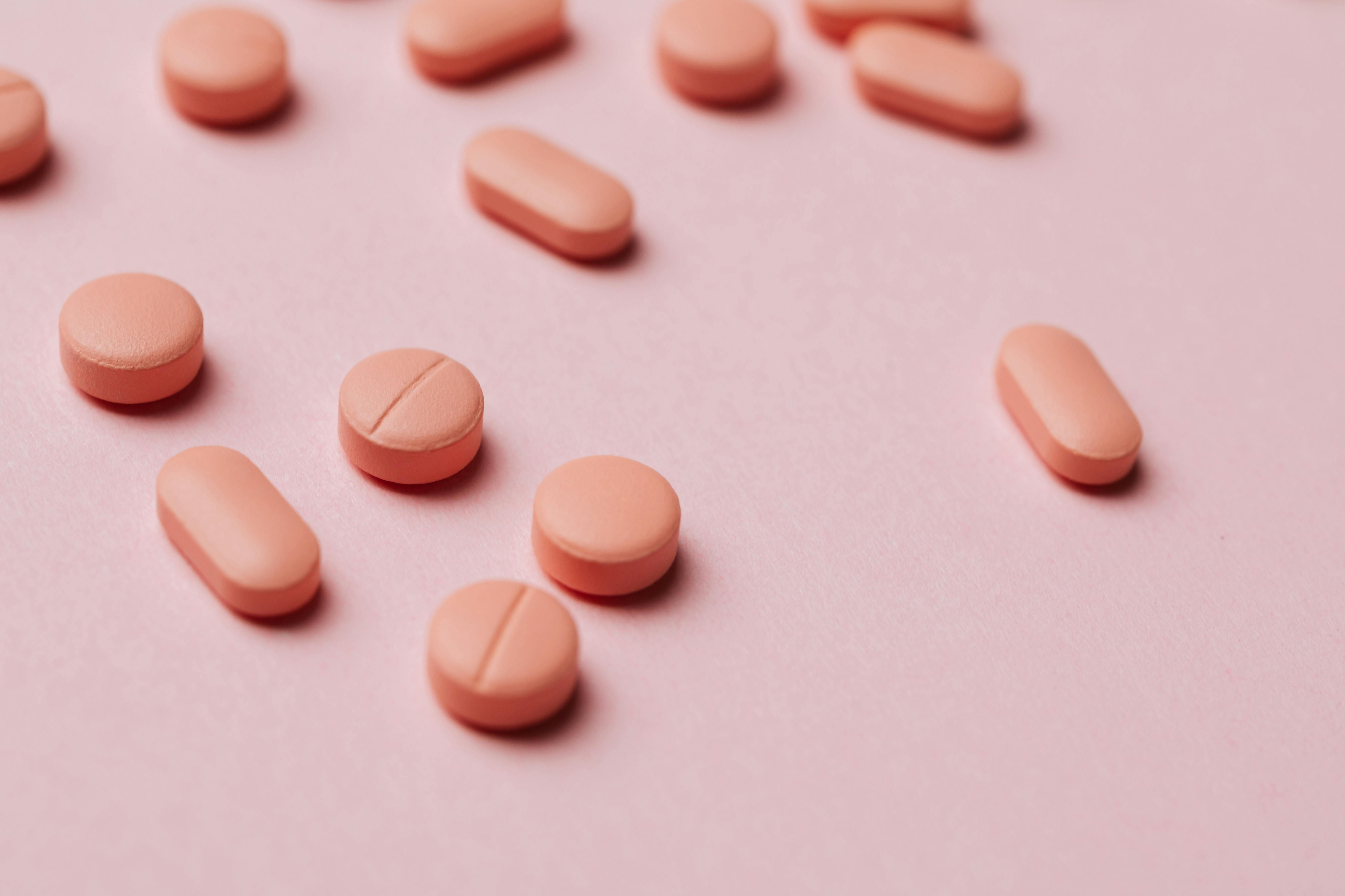 Melatonin pills on a table, highlighting women's sleep aid options