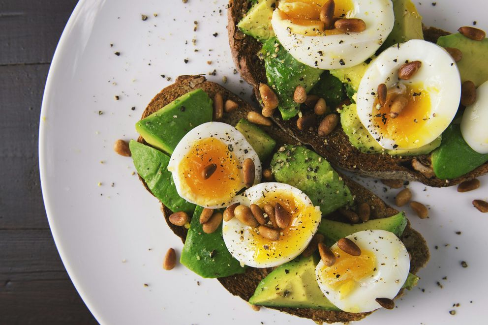 A woman enjoying a nutrient-dense meal, emphasizing the brain-boosting benefits of the MIND diet.