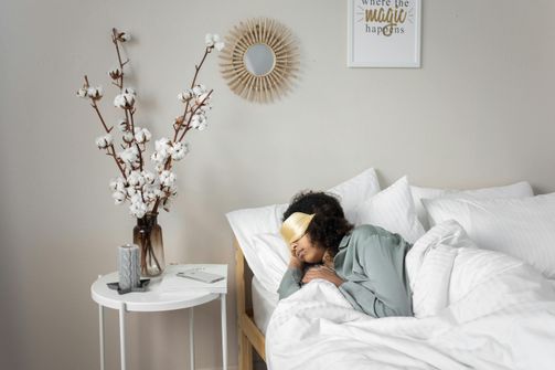 A woman taking a short nap during the afternoon to recharge energy and improve focus.