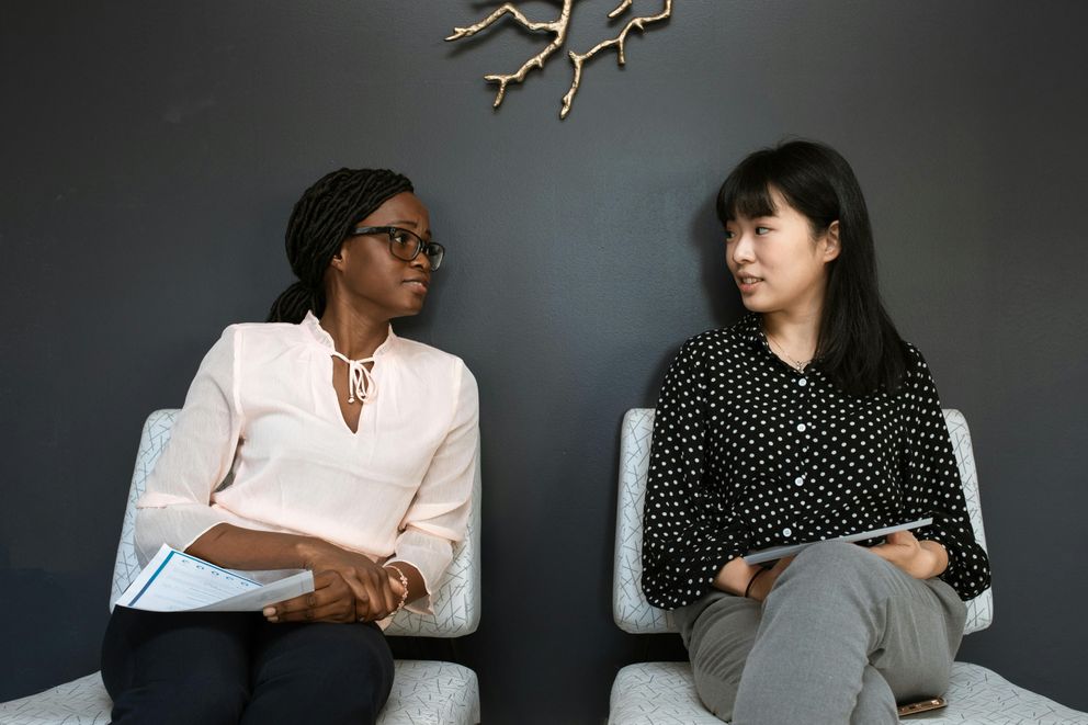 Women from diverse cultural backgrounds enjoying meals that reflect how blending different diets can support healthy weight loss.