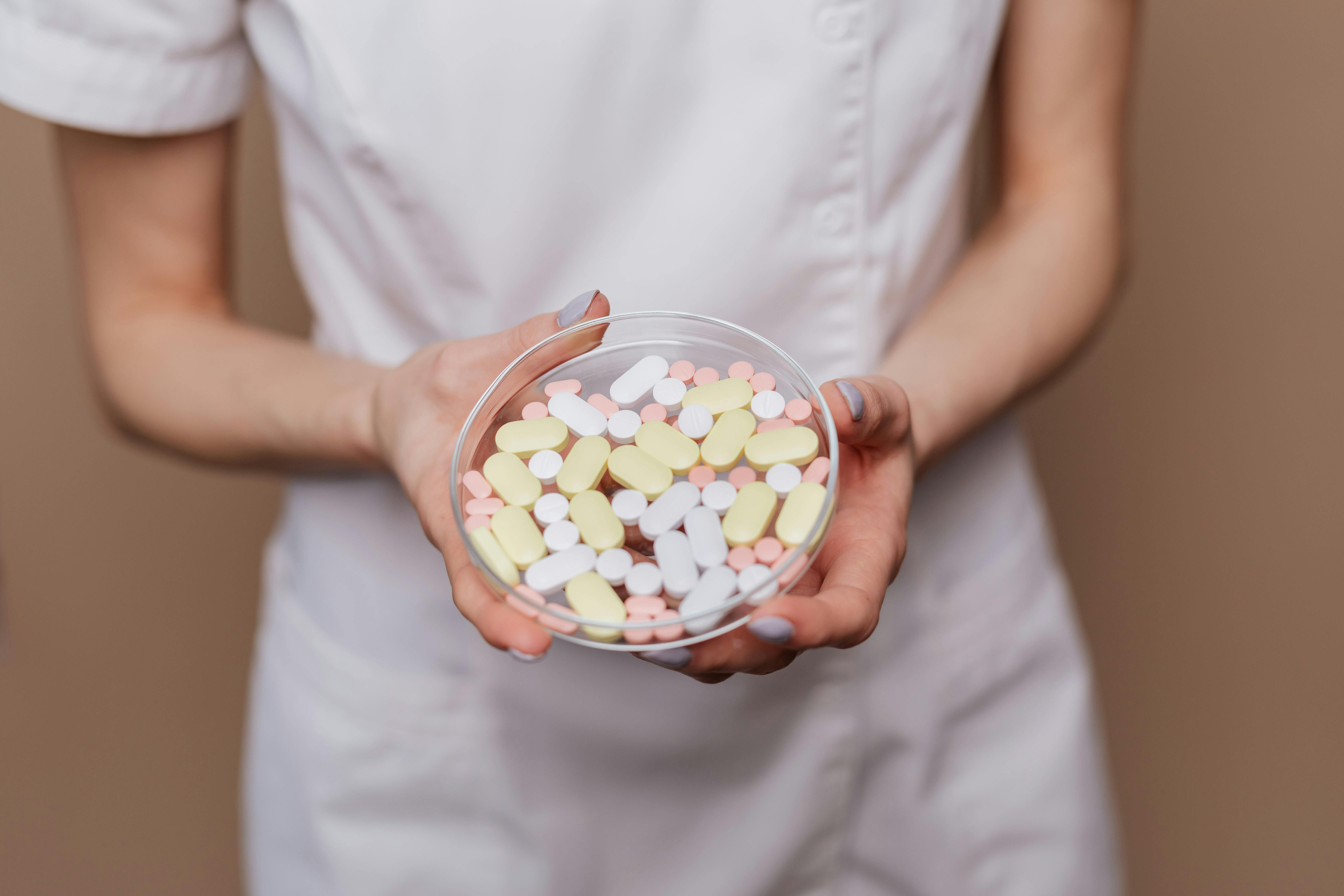 A nurse administering antibiotics to a patient while discussing the impact on intermittent fasting.