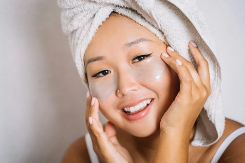 A woman peacefully sleeping in a dark, cool room to rejuvenate her skin and enhance her natural glow.