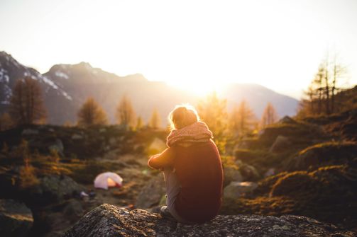 A woman enjoying solitude in nature, reflecting on her creativity and self-discovery.