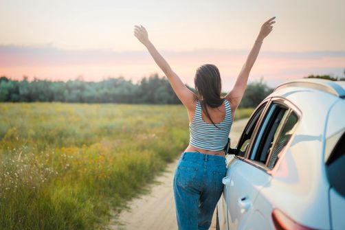 A woman traveling while staying active and maintaining her weight loss routine, including exercising, eating healthy, and staying hydrated.