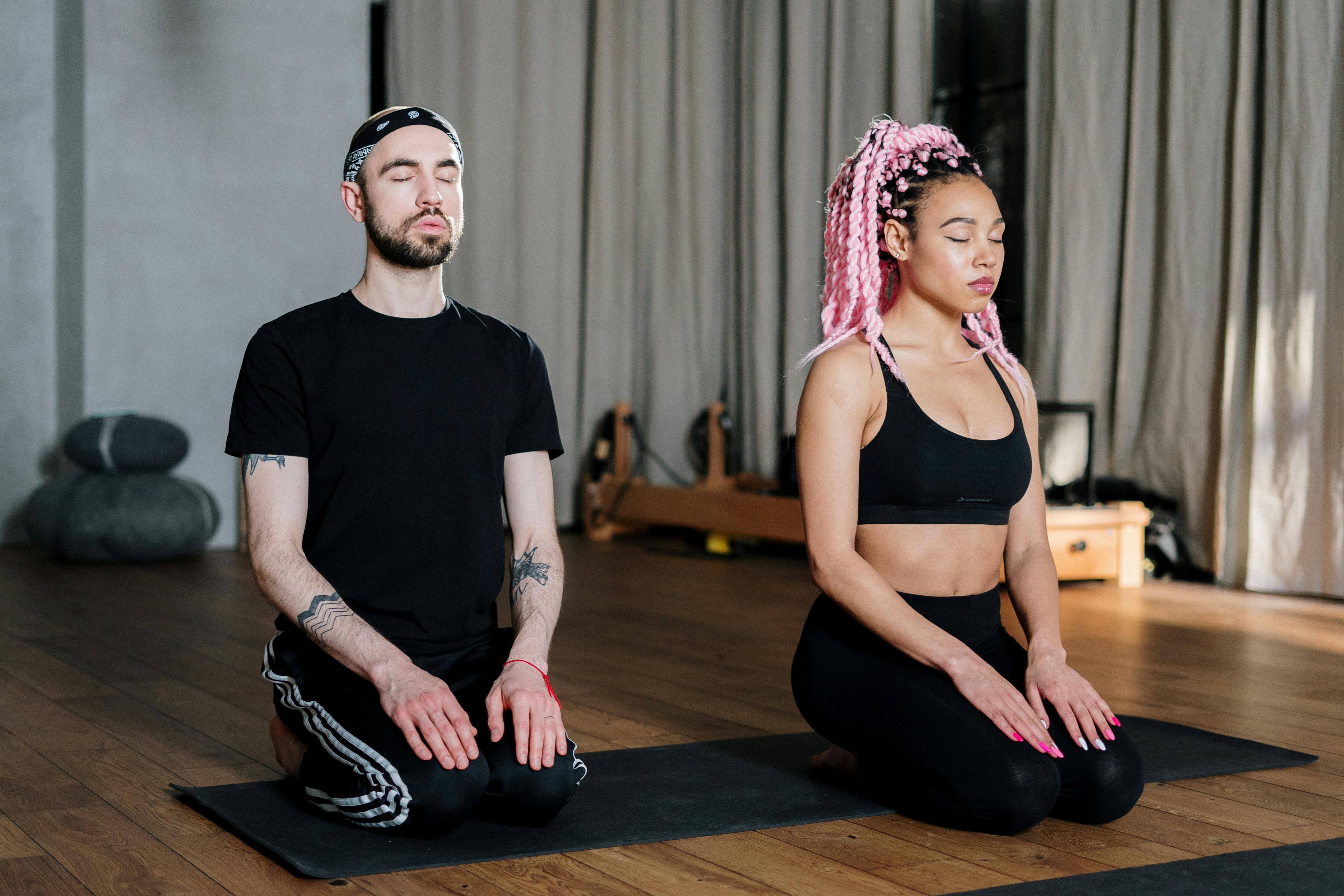 Man and woman meditating together, finding peace and balance