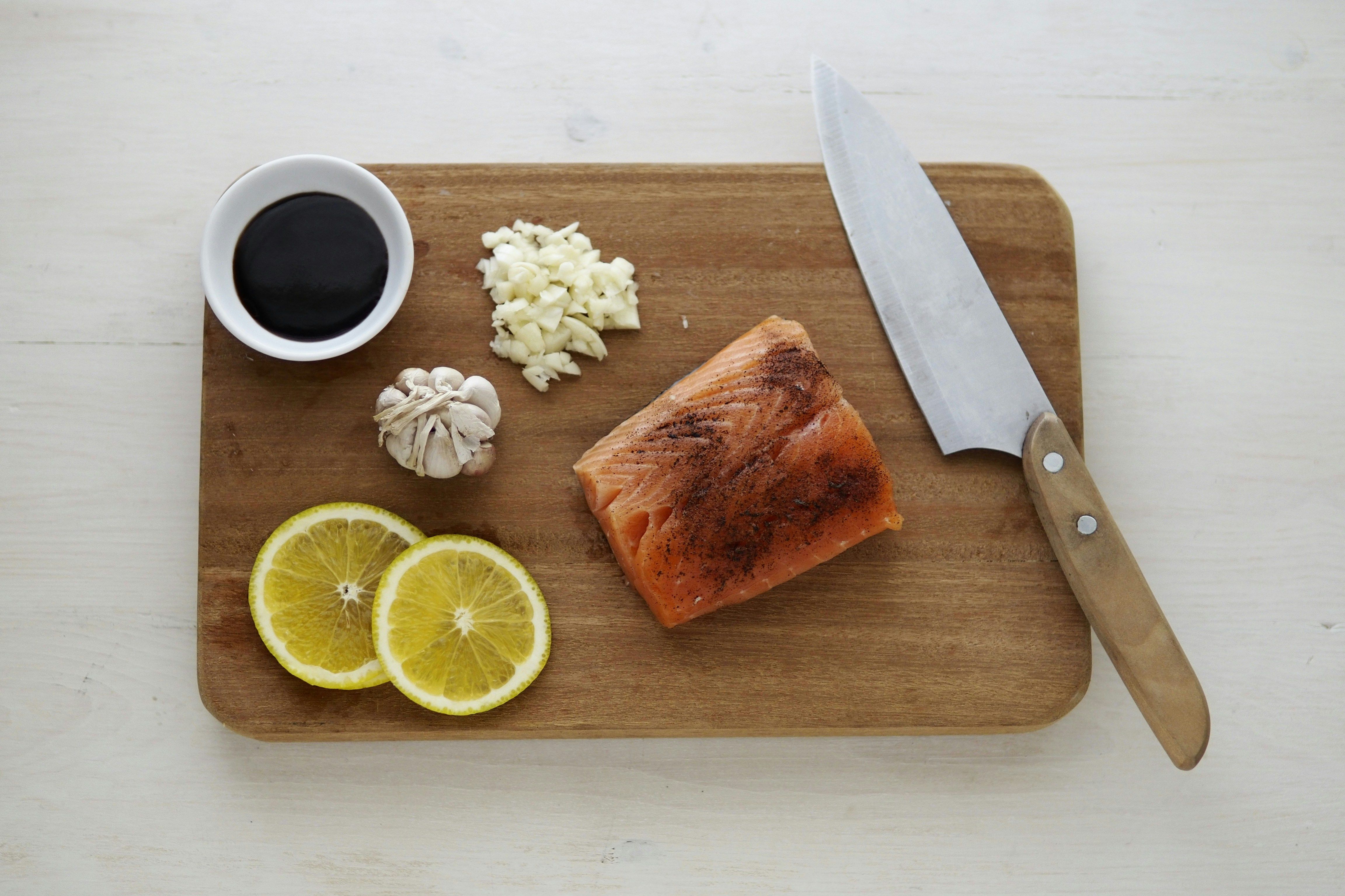 A woman cooking a Ketovore meal with fish