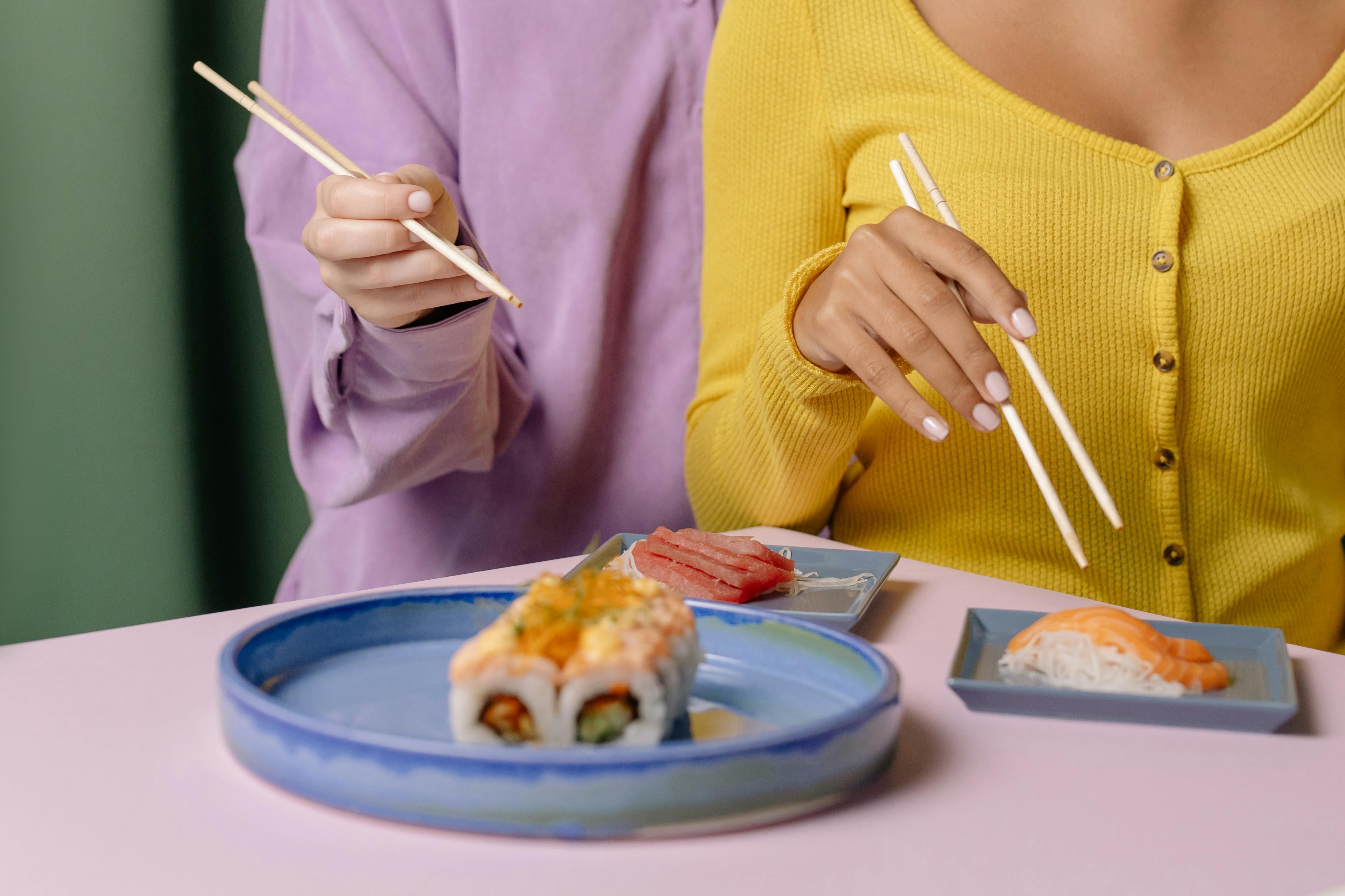 Woman enjoying salmon sushi, incorporating omega-3 into her diet