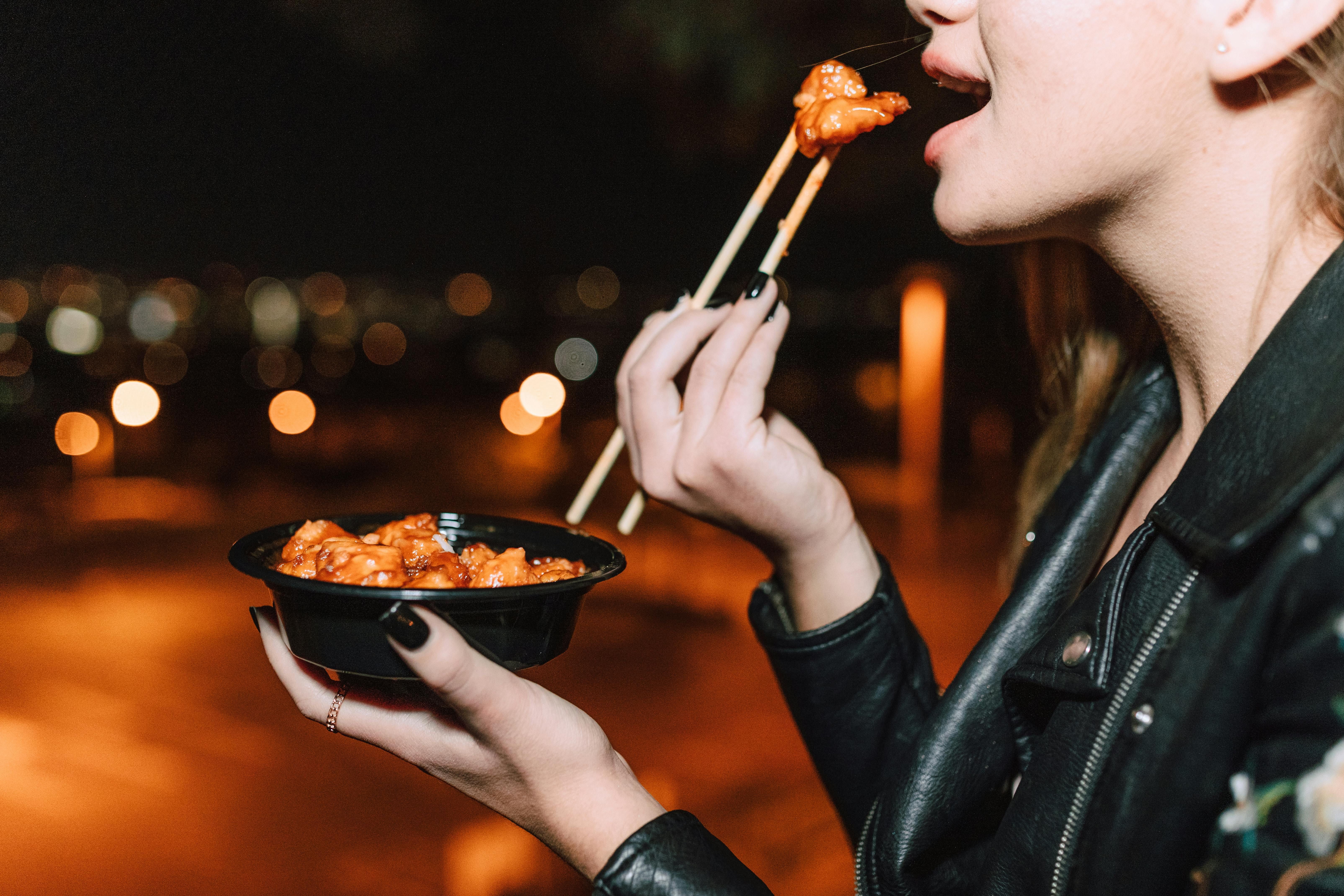 A woman enjoying a meal of nutrient-dense meat to meet her micronutrient needs on the carnivore diet.