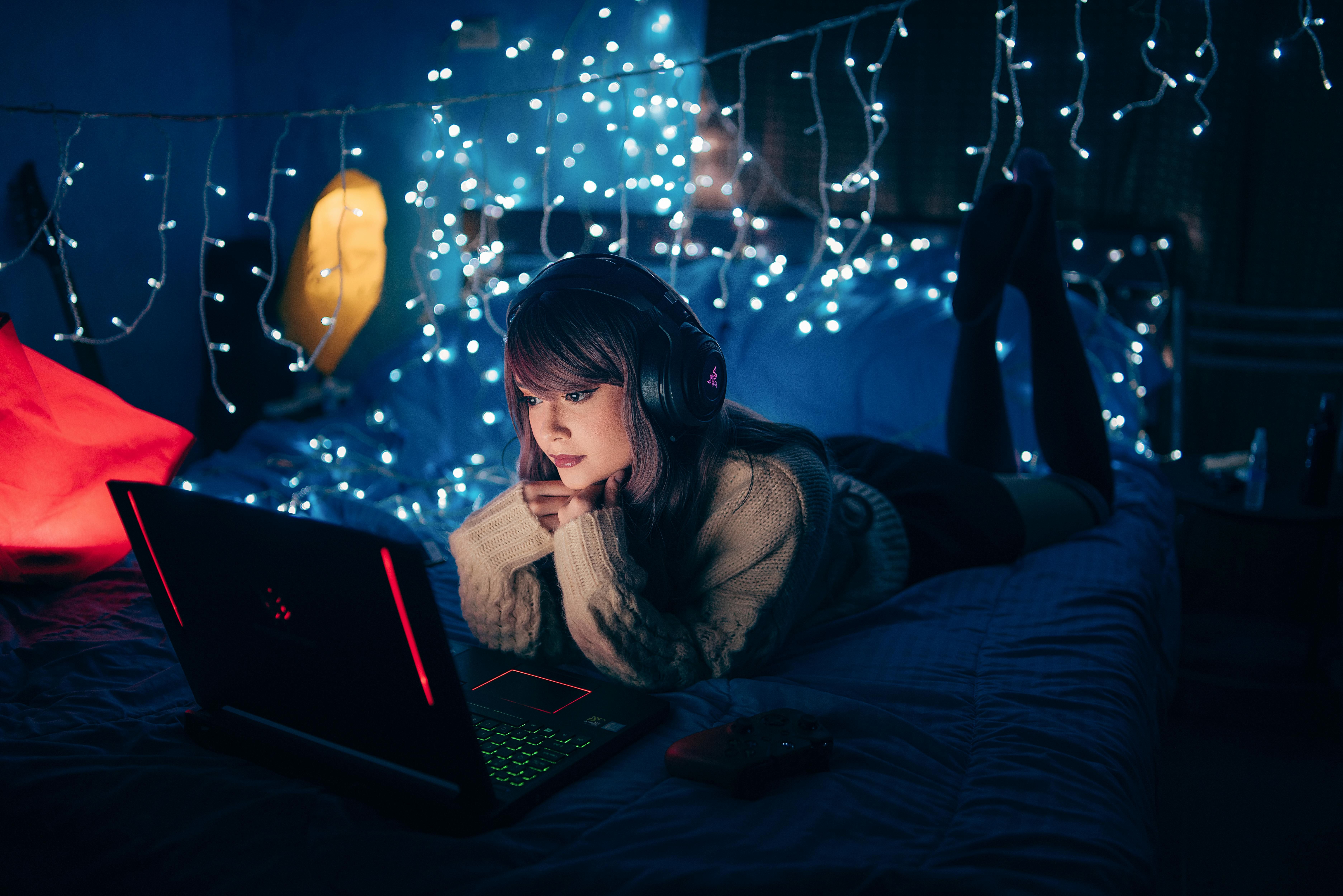 A woman lying in bed, listening to calming sounds like binaural beats or nature sounds to improve sleep and relaxation.