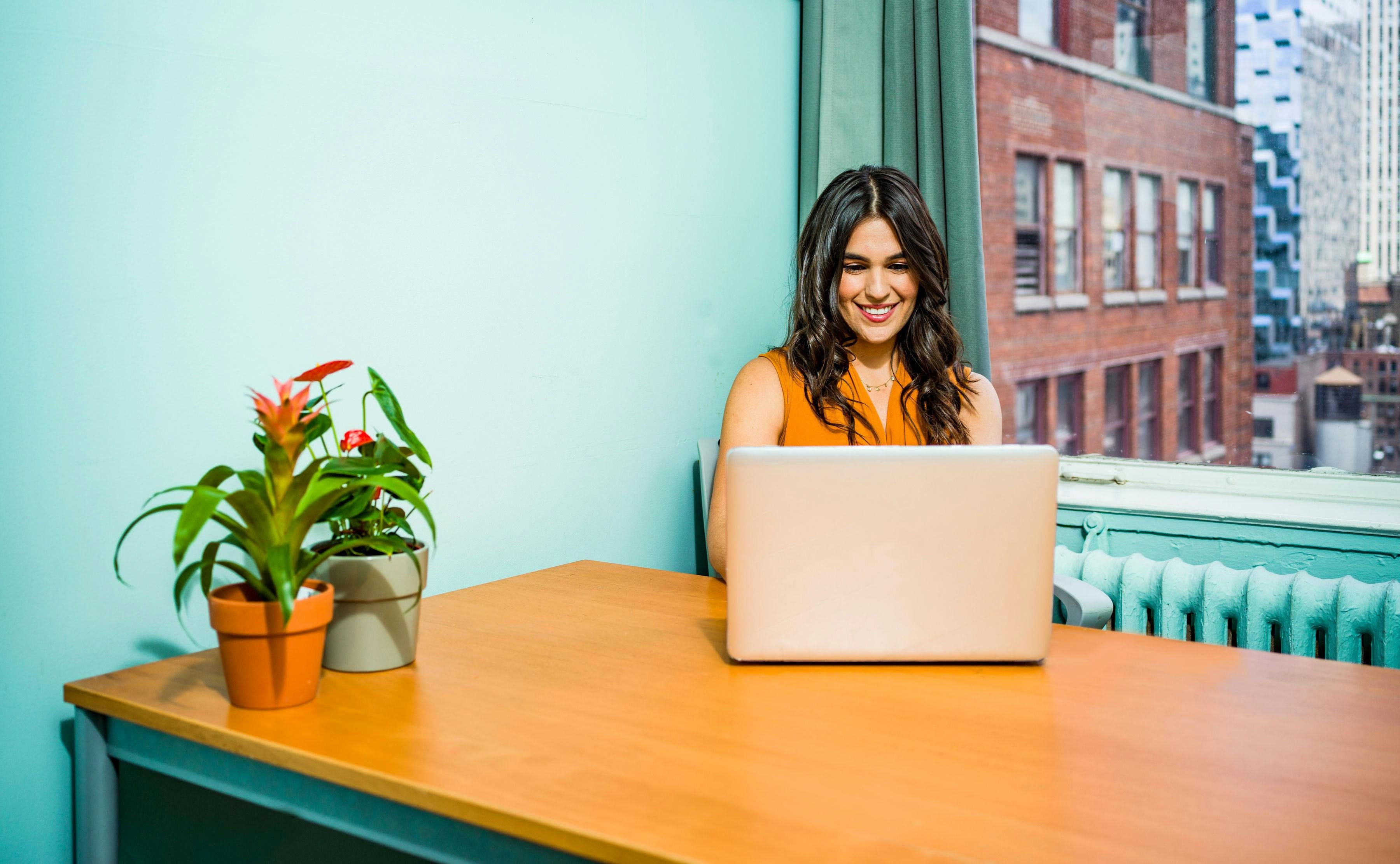 A woman talking online with her counselor at her workplace, using CBT strategies to manage career-related stress.