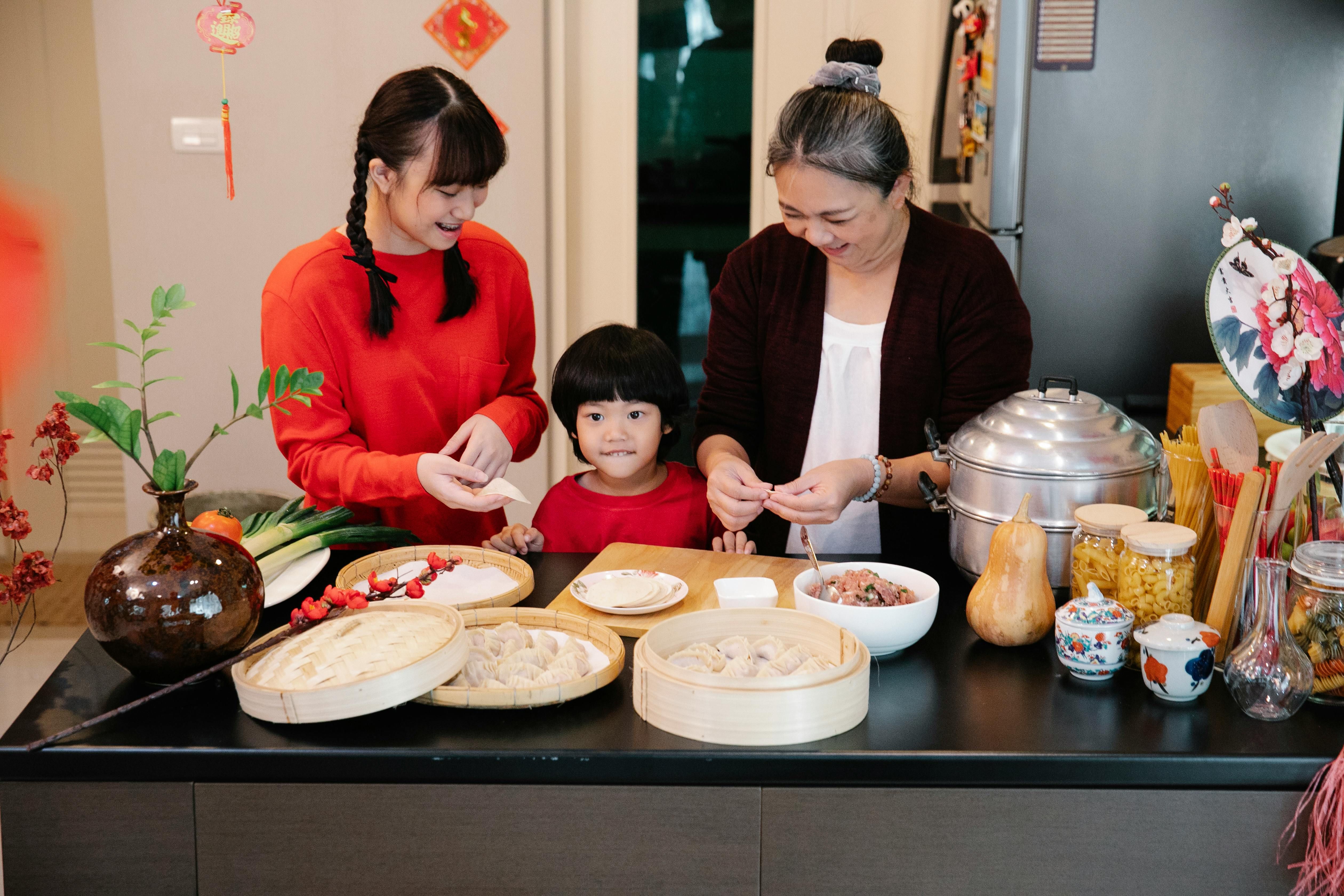 A family happily cooking meat together in the kitchen, highlighting the joy and togetherness of preparing a meal as a family.