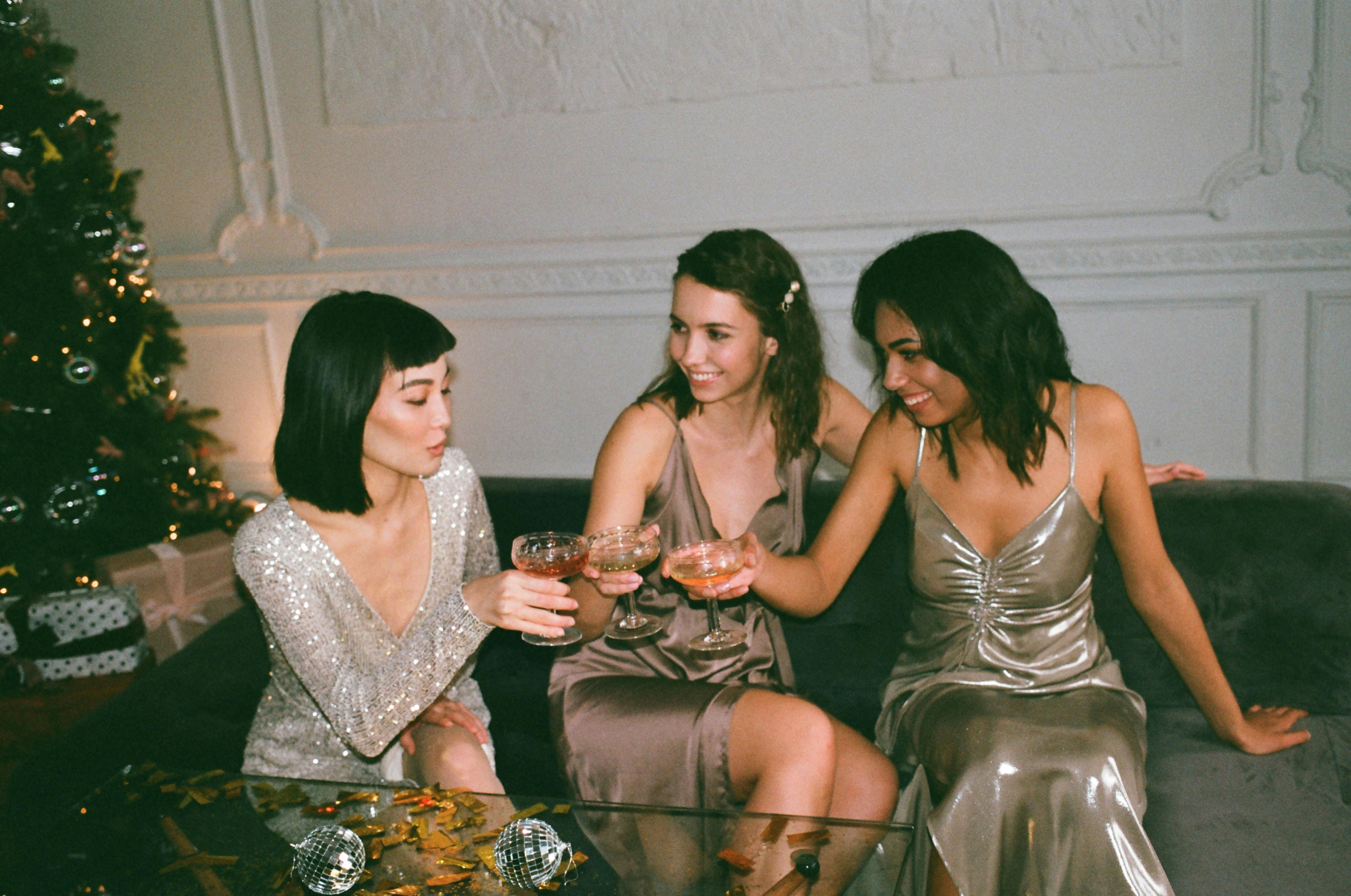 Three women enjoying non-alcoholic spirits, sharing a sophisticated and health-conscious drinking experience together.