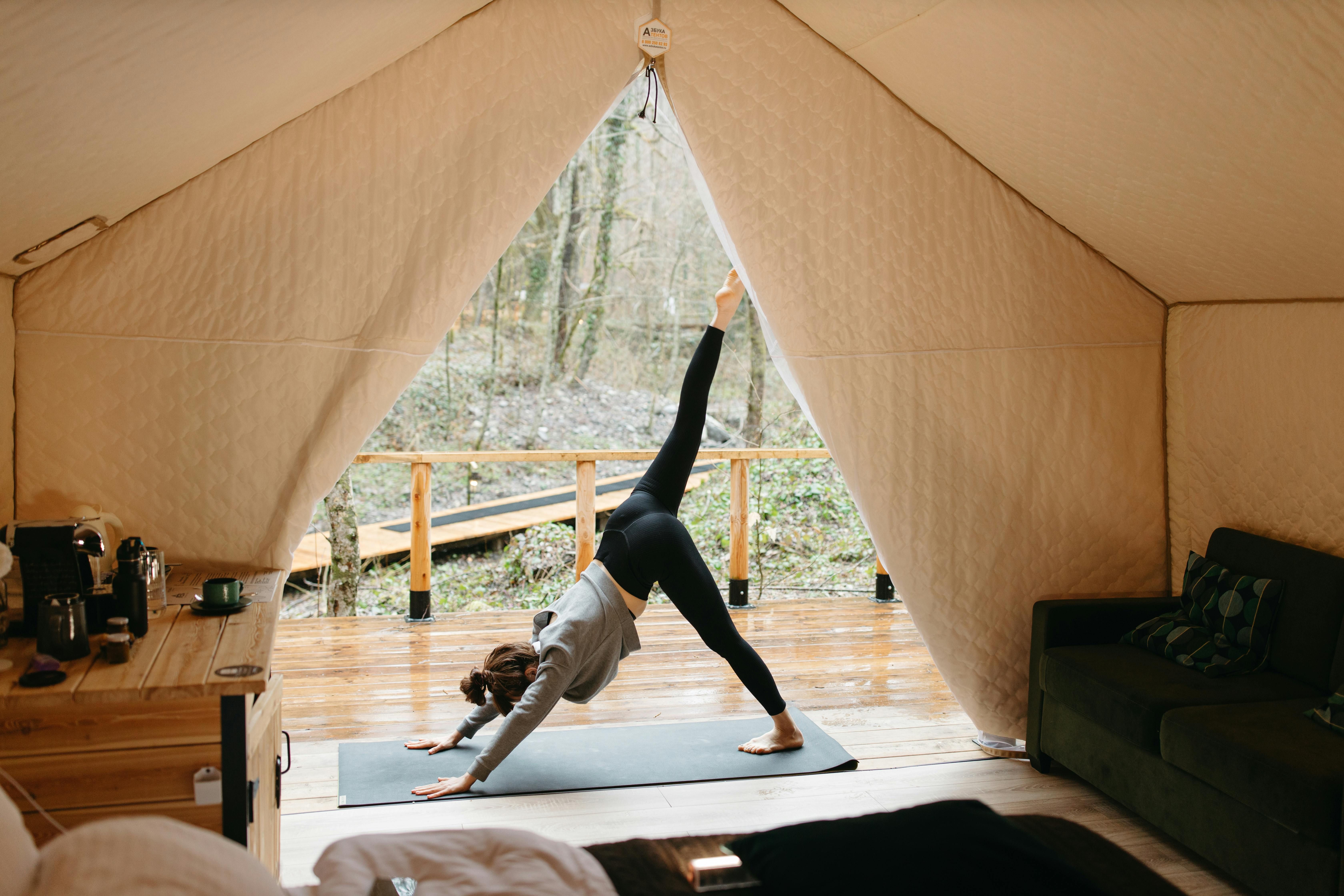 A woman practicing yoga in nature, embracing solitude to enhance emotional clarity and personal growth.